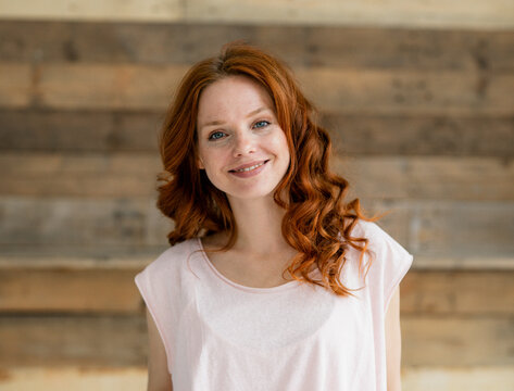 Portrait of smiling redheaded woman