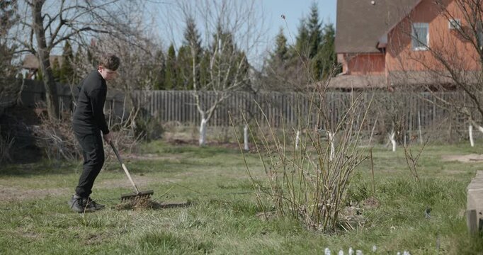 Kid Rakes Grass on Lawn. Caucasian Boy Help Working Around Backyard. 4K 10-bit