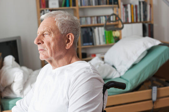 Pensive man sits in a wheelchair in an apartment sharing community