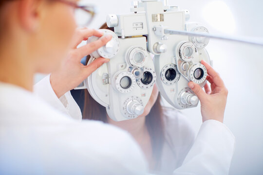 Eye doctor examining woman's vision