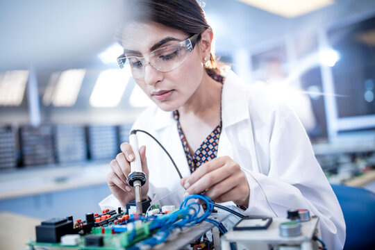 Female technician working on motherboard