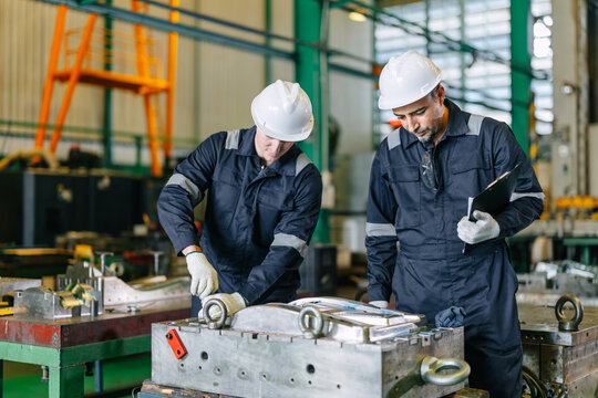 Engineer worker team service injection mold, Professional men work in die casting plant mold service