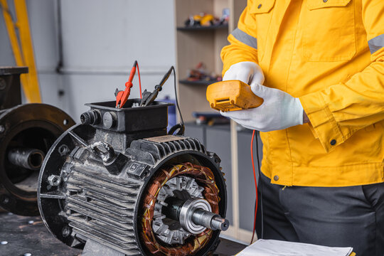 Engineer Checking DC Motor, Technician Man in Garage check inspecting service maintenance Stator.