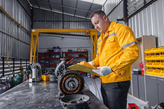 Engineer Checking DC Motor, Technician Man in Garage check inspecting service maintenance Stator.