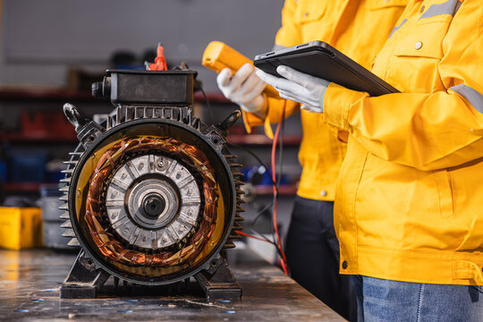 Engineer Checking DC Motor, Technician Man in Garage check inspecting service maintenance Stator.