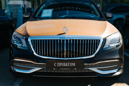 A Maybach luxury car is displayed prominently at a dealership, highlighting its distinctive front grill and design. Smolensk, Russia 07.17.2026