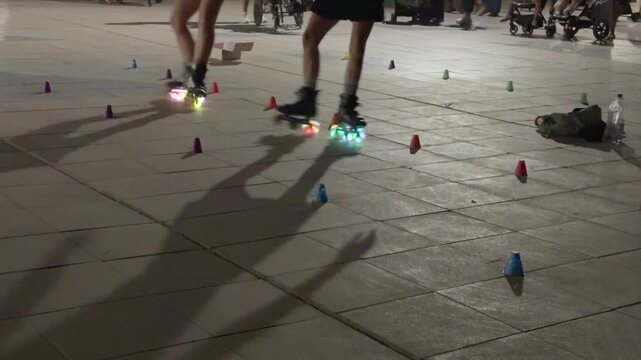 Slalom rollerblading with glowing led wheels at night
