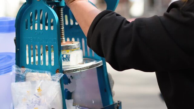 Street Vendor Using Manual Shaved Ice Machine in Bangkok