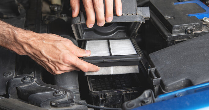 Man change a car cabin air filter.