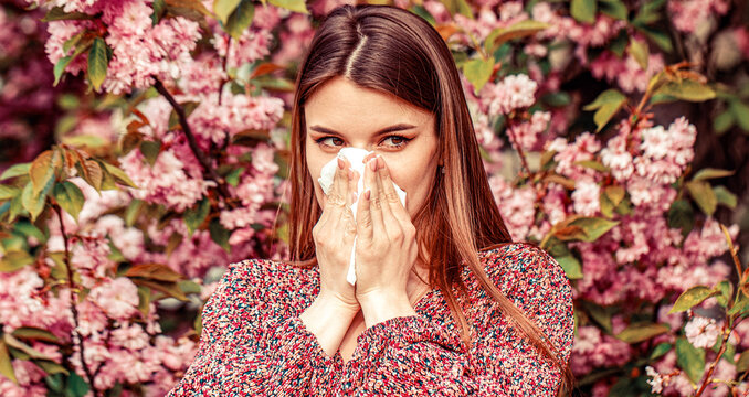Allergy. Sick women sneezes in tissue, suffers from rhinitis, running nose