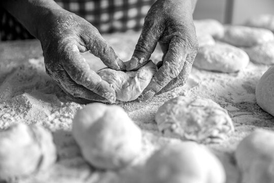 Woman hands rolling doughs for pies. Baking at home. Black and white