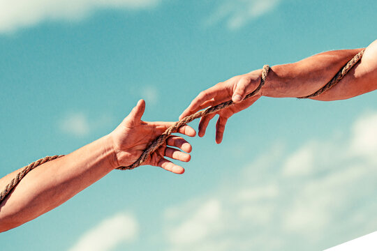 Conflict tug of war. Two hands, helping hand, arm, friendship. Rope, cord