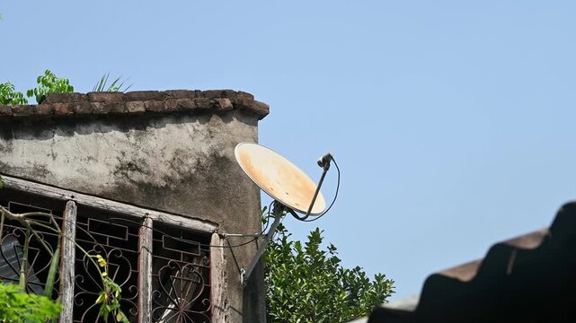 A DTH (Direct-to-Home) connection dish antenna is installed on a roof wall facing south of a house situated in a forest. United States has listed India&rsquo;s preference for the use of domestic satellites 