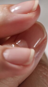 woman applying nail harder strengthener cosmetics serum 