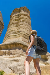 Young woman exploring Love valley rock formation in Cappadocia. Discovery and geological heritage concept.