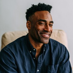 Fototapeta premium Confident smiling man in navy shirt on neutral backdrop for vertical portrait and professional profile banner design