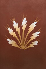 Obraz premium Stylized gold leaf burst on warm terracotta background for elegant wallpaper and poster design