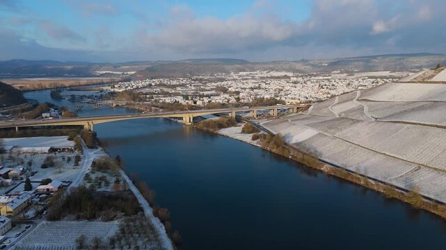 Snow covered Moselle valley, vineyards and Mosel river, Viaduct Longuich bridge of highway crossing near Trier, aerial view, winter season with frost in Germany