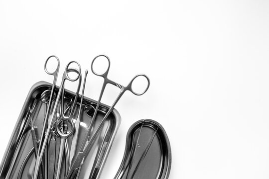 Sterile surgical instruments and tools - scalpels, scissors and others - in a stainless tray, top view