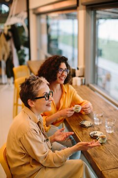 Diverse women enjoying conversation during coffee break