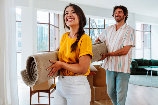 Happy young couple relocating in a new apartment.
