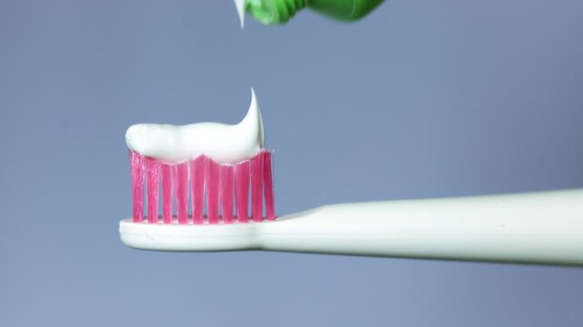 Squeezing toothpaste onto a toothbrush for daily dental hygiene routine