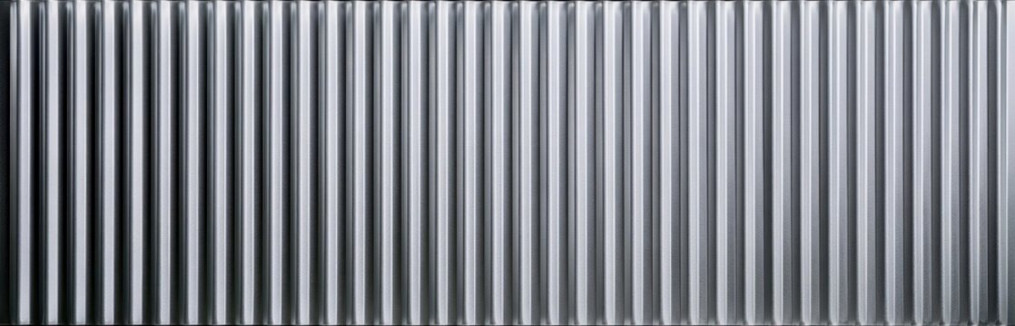 Silver corrugated metal surface with vertical ridges and weathered texture