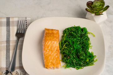 baked  seasoned salmon  served with seaweed salad © dmiller324
