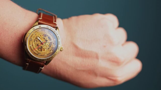 Close-up of a man's wrist wearing a vintage skeleton automatic watch