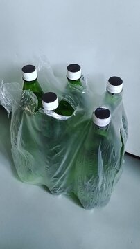 bottled water stored at home, female taking drinking water bottle, clean water reserve and household emergency supplies.