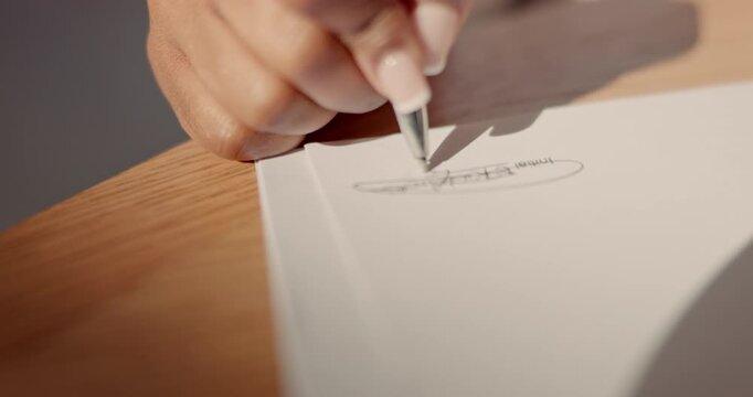 Signature, contract and hand of an employee with a pen on paper for agreement, business and deal. Law, working and person signing a legal document for employment, loan or mortgage on paperwork