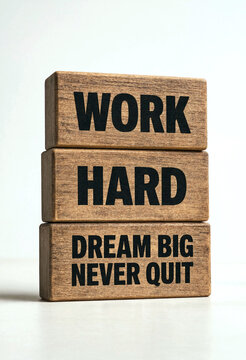 Motivational wooden blocks with work hard dream big never quit message stacked together creatively