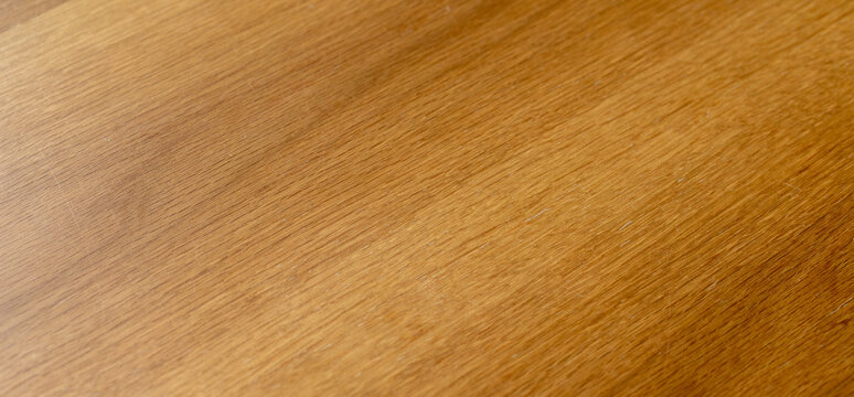 Smooth warm brown wooden surface texture background with natural fine grain