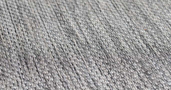 Grey woven fabric carpet texture background with detailed close up pattern