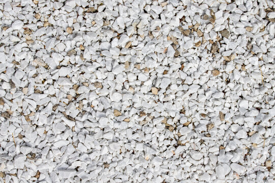 White crushed gravel ground surface texture background with small stones