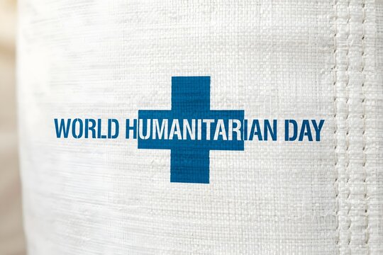 World humanitarian day text with a blue medical cross symbol, humanitarian