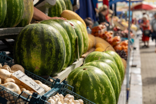 Lots of watermelons in the city market.
