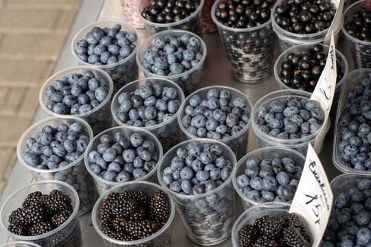 Blueberries on a market stall. Blueberries in trays are sold at the market.