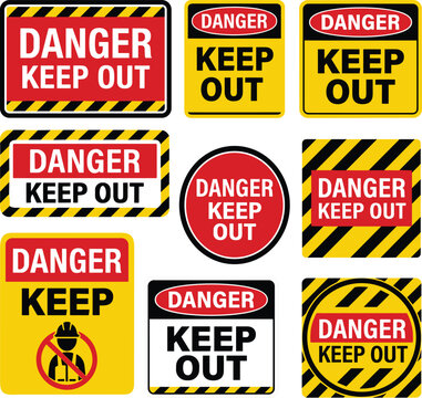 Collection of various danger keep out warning signs and safety labels for industrial and construction site use