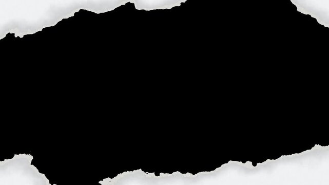 White textured paper tearing and opening to reveal black background transition