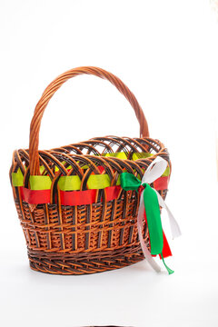 Wooden branch basket with ribbons on a white background