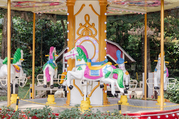 Carousel with colorful horses at amusement park © fadfebrian