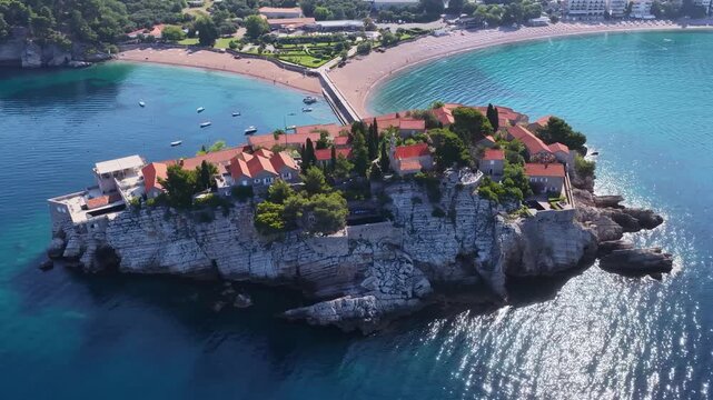 Aerial view of the island of St. Stefan on the Adriatic coast of Montenegro in Mediterranean Sea, showing the coastline and architecture. It is an island resort and popular summer vacation destination
