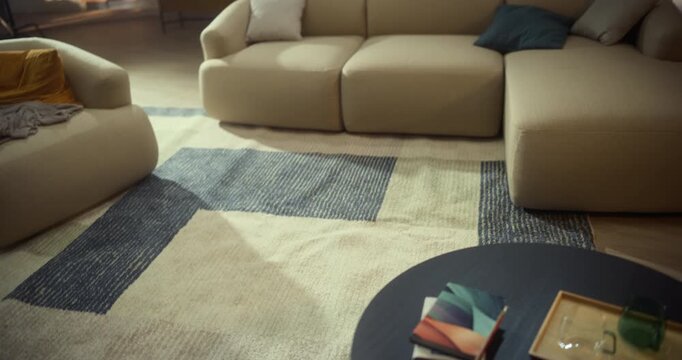 Whirling Camera Sweeps Across Living Room and Cozy Couch to a Coffee Table With Notebooks, Framing an Inviting Modern Apartment Open Space. Stylish Home