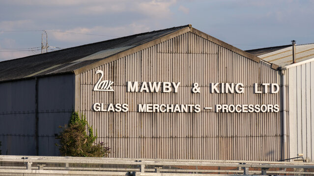 Leicester, England, UK - 21 July 2026: Industrial building, warehouse wall, metal facade, Mawby and King Ltd signage, glass processors company