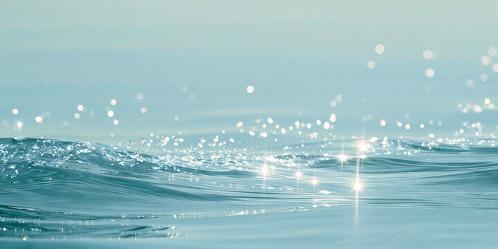 Abstract soft blue sparkling water wave texture with sun reflections