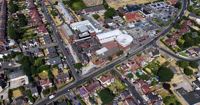 Aerial footage of Montagu Hospital in Mexborough South Yorkshire England showing the hospital complex surrounding residential housing cemetery and healthcare buildings captured from a drone