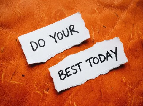 Handwritten motivational message, "DO YOUR BEST TODAY," on torn paper, inspiring action and productivity, set against a textured orange background.