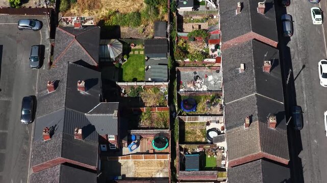 Aerial footage looking directly down over rear gardens and detached homes in a residential neighbourhood of Mexborough South Yorkshire England showing private gardens outbuildings surrounding streets
