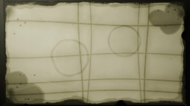 Turning spool pulling translucent film cell across lightbox at studio, advancing strip, with stains